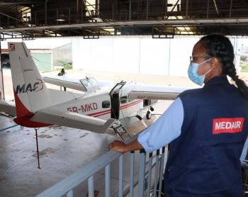 MAF 5R-MKD aircraft and Medair representative in MAF hangar