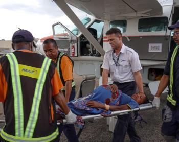 Patrick Keller, MAF pilot carrying a patient with the ground OPS