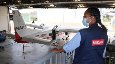 MAF 5R-MKD aircraft and Medair representative in MAF hangar