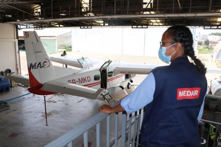 MAF 5R-MKD aircraft and Medair representative in MAF hangar