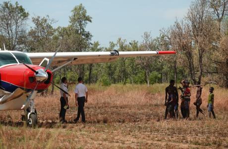 MAF pilots next to aircraft and local people
