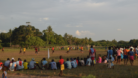 Locals gather to watch a football game