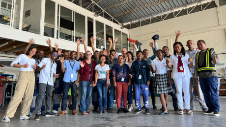 Group picture of MAF Madagascar staff in hangar